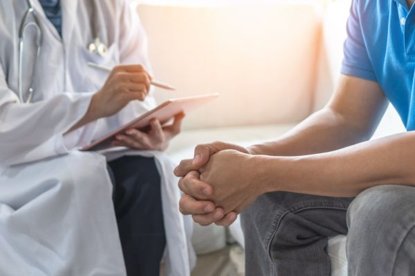 A Male doctor checking the back of the patient